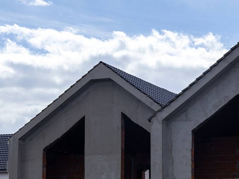 imgi_66_construction-of-new-houses-in-a-suburban-area-with-clear-blue-sky-and-clouds-visible-in-the